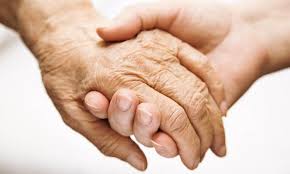 Stepping In to help with financial protection holding hands younger person hand holding elderly senior hand