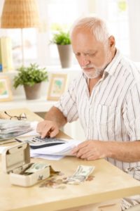 Elderly man acting as money manager and doing finances