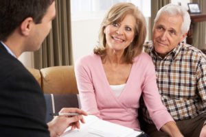 Senior citizens couple meeting with daily money manager smiling financial management