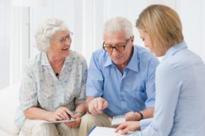 elderly couple avoiding financial threats with help from a money manager