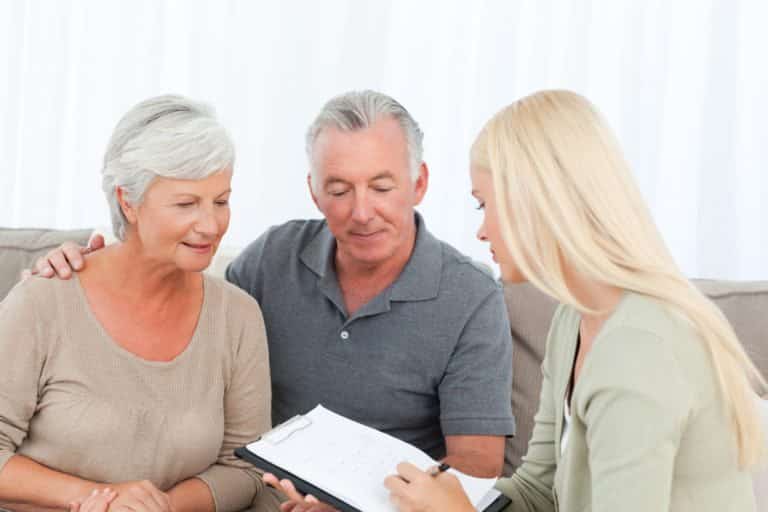 Elderly couple sitting with a money manager